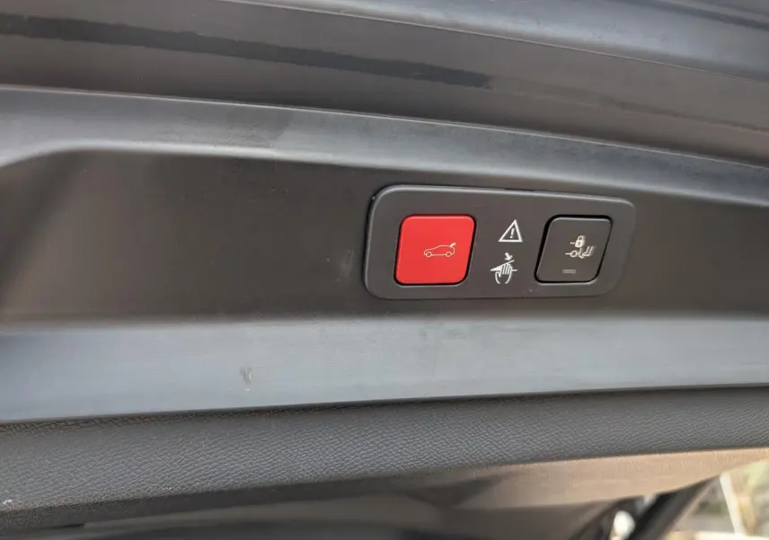 Détail du hayon motorisé gris du Peugeot 5008 GT 2023 avec boutons d'ouverture et de fermeture mains libres.