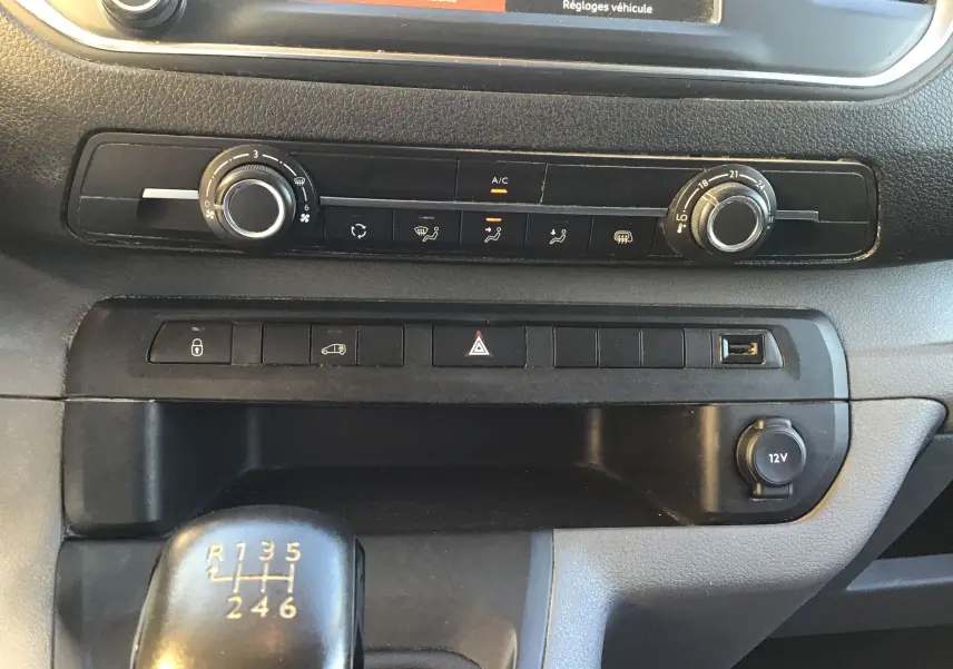 Gros plan sur la console centrale du Citroën Jumpy XL blanc 2021, avec commandes climatisation et levier de vitesse manuel.