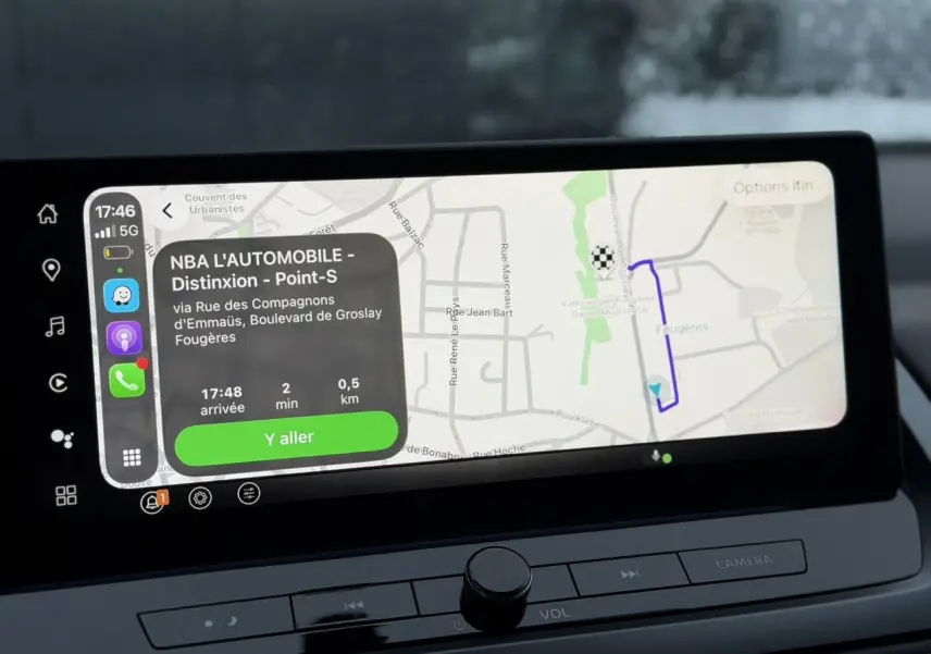 Écran tactile du système de navigation du Nissan Qashqai 2025 affichant un itinéraire en ville.