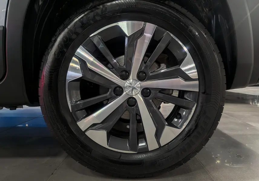 Gros plan sur la jante alliage bi-ton du côté gauche du Peugeot Rifter 2024 gris Artense, version BlueHDi 130 GT.