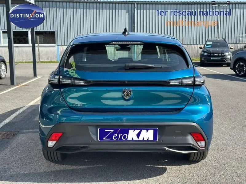 Vue arrière d'une Peugeot 308 bleu Obsession 2025 avec feux arrière LED et logo noir brillant visible.