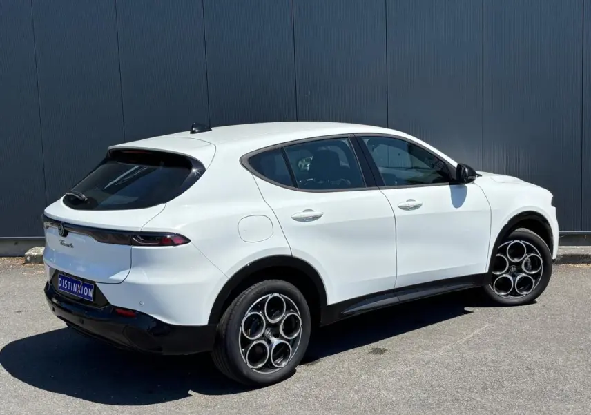 Vue 3/4 arrière droite de l'Alfa Romeo Tonale blanc métallisé avec jantes alliage 18 pouces et vitres teintées.