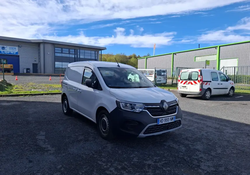Renault Kangoo Pro blanc vu en 3/4 avant droit, avec calandre noire et jantes acier, stationné en extérieur.