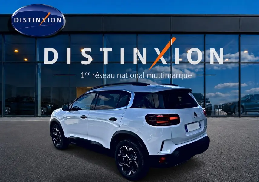 Citroën C5 Aircross blanc vue 3/4 arrière droit, avec toit noir et jantes alliage distinctives.