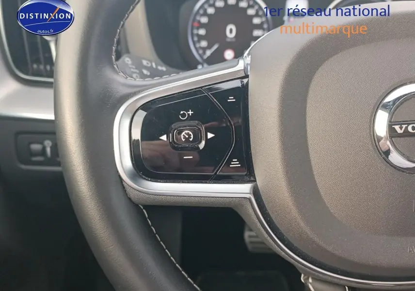 Gros plan sur la partie gauche du volant cuir multifonction du Volvo XC60 blanc 2021, avec commandes de régulateur de vitesse.