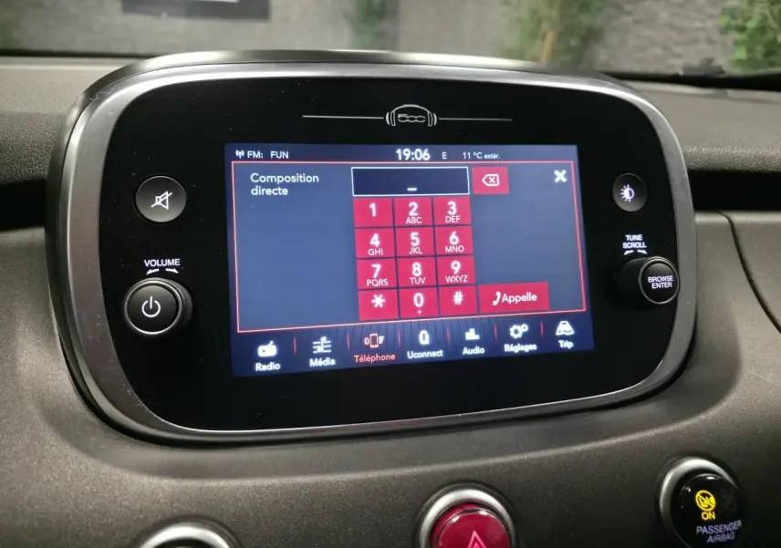 Écran tactile central du tableau de bord de la Fiat 500X 2024 affichant le clavier de composition téléphonique.