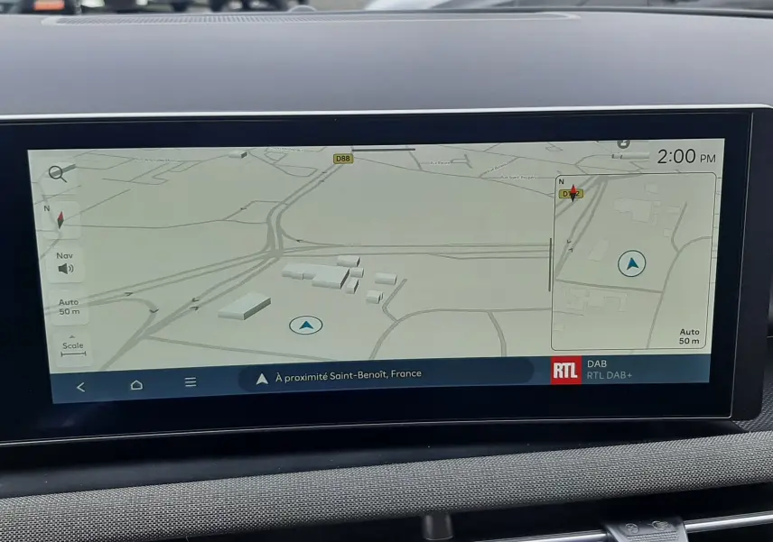 Écran tactile central du Hyundai Tucson 2025 affichant la navigation GPS avec carte et options multimédia, intérieur gris.