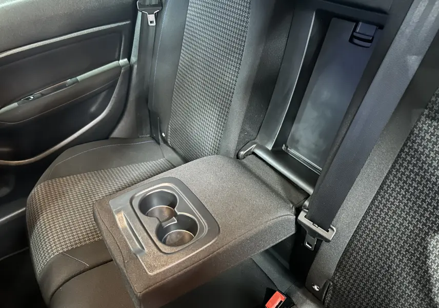 Détail de l'accoudoir central arrière avec porte-gobelets dans l'habitacle tissu noir de la Peugeot 308 SW 2018.