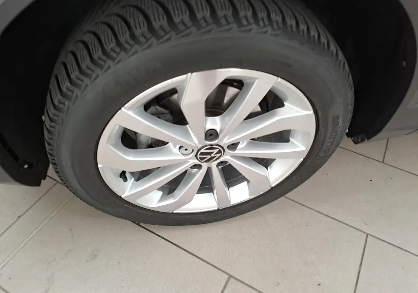 Gros plan sur la jante alliage 17'' Johannesburg d'un Volkswagen T-Roc gris Indium, roue avant droite visible.