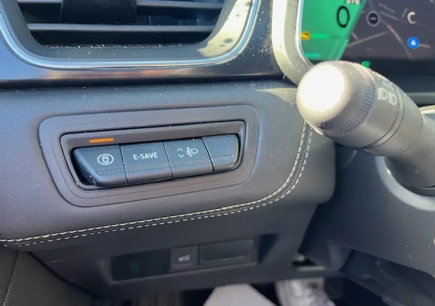 Gros plan sur les commandes noires du tableau de bord côté gauche du Renault Symbioz 2025, avec surpiqûres blanches.