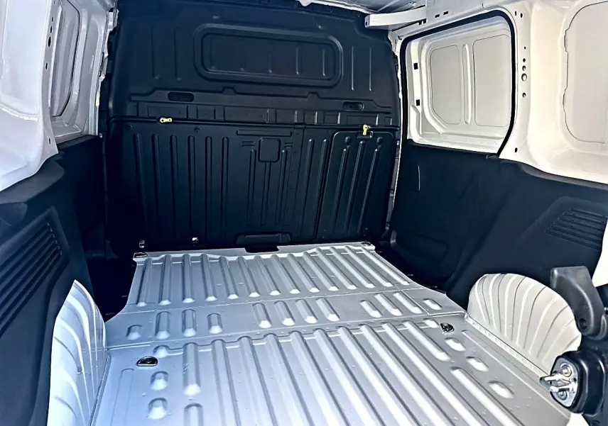 Vue intérieure arrière du coffre blanc du Citroën Berlingo Fourgon M diesel 100 avec cloison pleine noire.