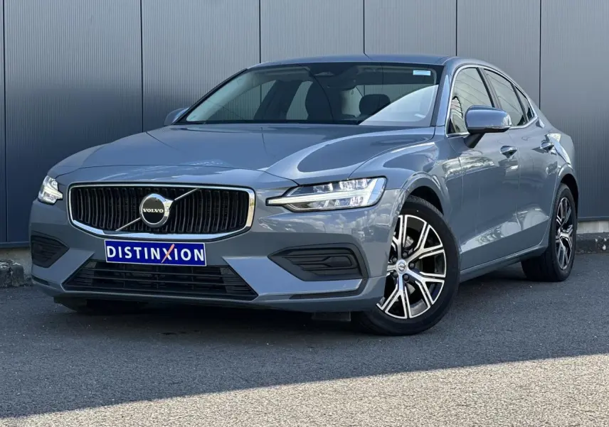 Volvo S60 B4 2024 gris Thunder vue 3/4 avant avec jantes alliage 17 pouces et calandre chromée.