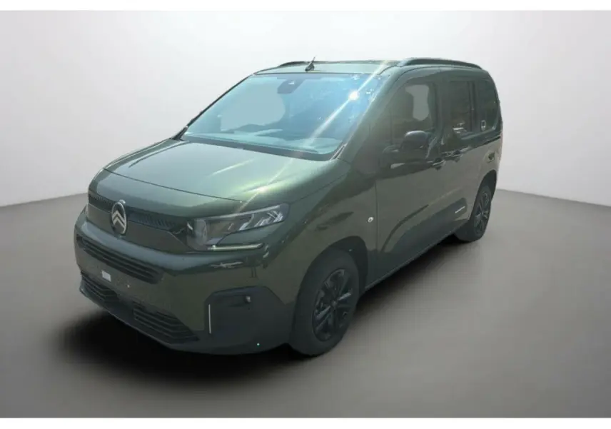 Vue 3/4 avant du Citroën Berlingo 2025 en vert Sirka métallisé avec jantes alliage noires et calandre marquée.