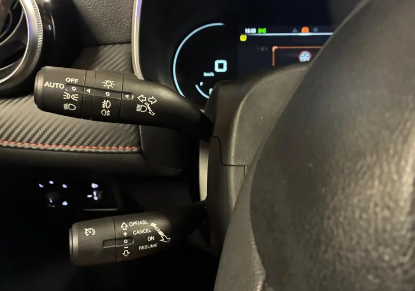 Gros plan sur les commandes au volant du MG ZS 2022, avec tableau de bord numérique et finitions intérieures noires.