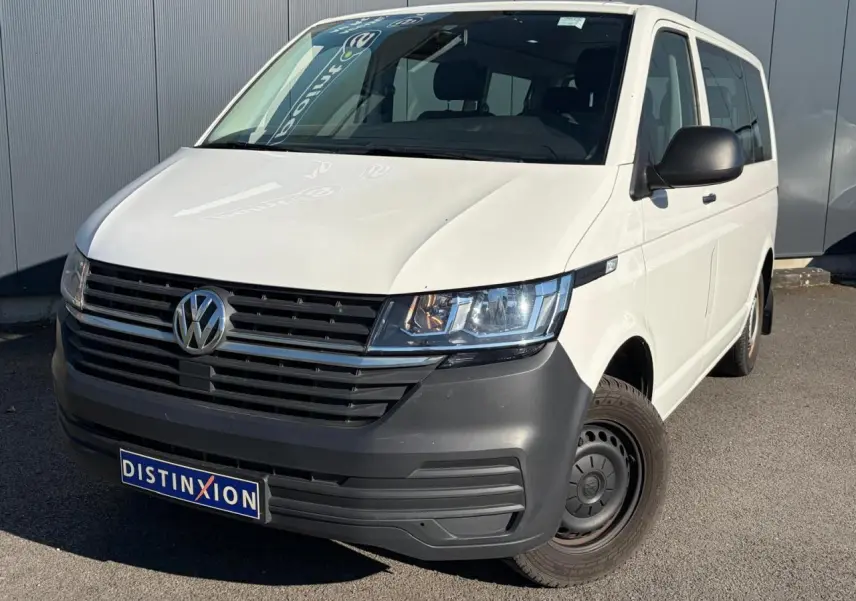 Vue 3/4 avant droit d'un Volkswagen Transporter T6 Minibus blanc avec pare-chocs noir et jantes acier.