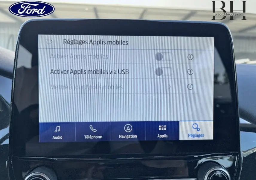 Écran tactile central du Ford Puma 2022 affichant les réglages des applications mobiles, intérieur noir.