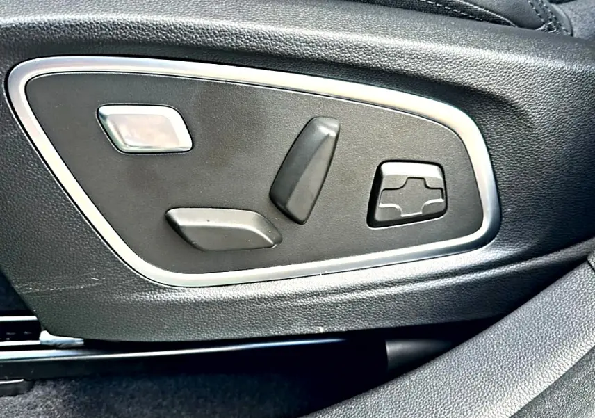 Gros plan sur les commandes électriques de réglage du siège en cuir noir du Renault Austral 2026 esprit alpine.