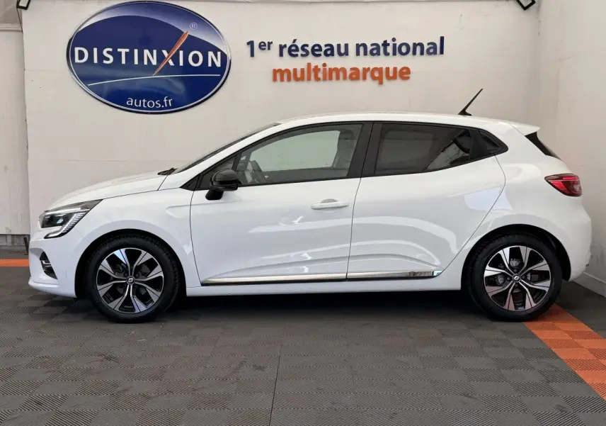 Profil côté gauche d'une Renault Clio Evolution TCe 100 GPL blanche, avec jantes alliage et vitres teintées.