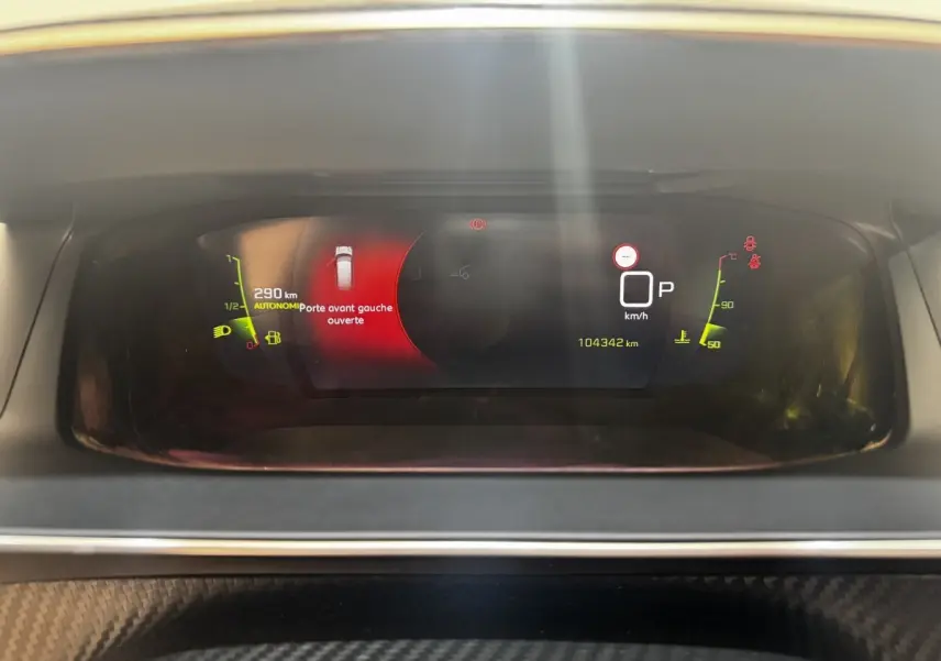Tableau de bord numérique du Peugeot 2008 noir, affichant porte avant gauche ouverte et compteur kilométrique.