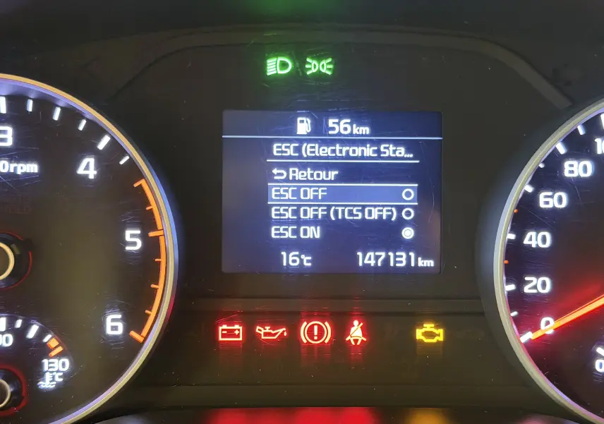 Tableau de bord du Kia Sportage gris 2019, affichage central avec options ESC et voyants d'alerte allumés.