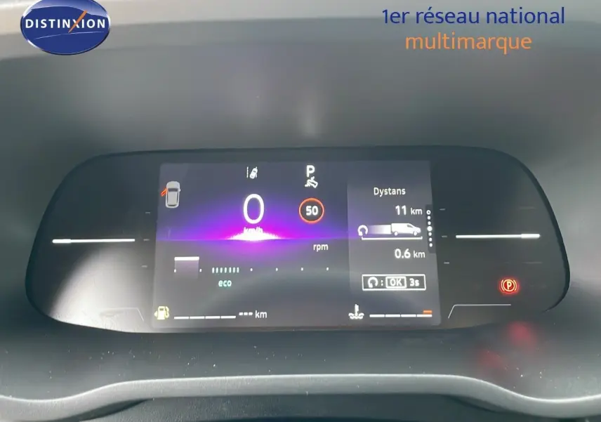 Tableau de bord numérique du Renault Trafic Fourgon blanc glacier 2025 affichant vitesse à 0 km/h et indicateurs de distance et parking.