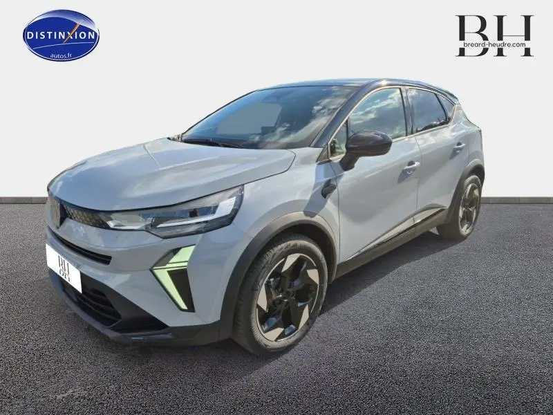 Renault Captur 1.6 E-Tech gris Rafale métallisé vue 3/4 avant droit avec toit noir et jantes noires distinctives.