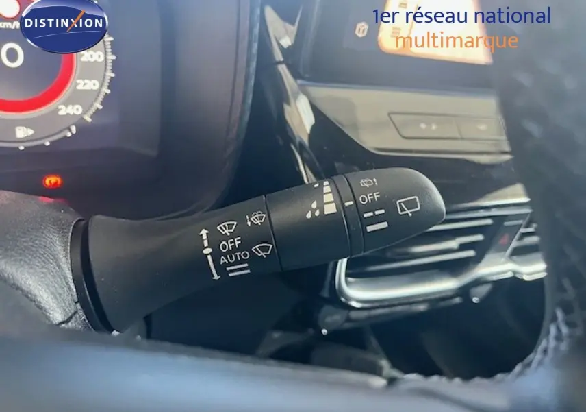 Gros plan sur la commande d'essuie-glace à gauche du volant dans un Nissan Juke bleu magnétique 2025.