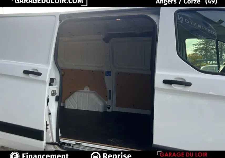 Vue latérale droite d’un Ford Transit Custom blanc avec porte coulissante ouverte montrant l’espace de chargement vide.