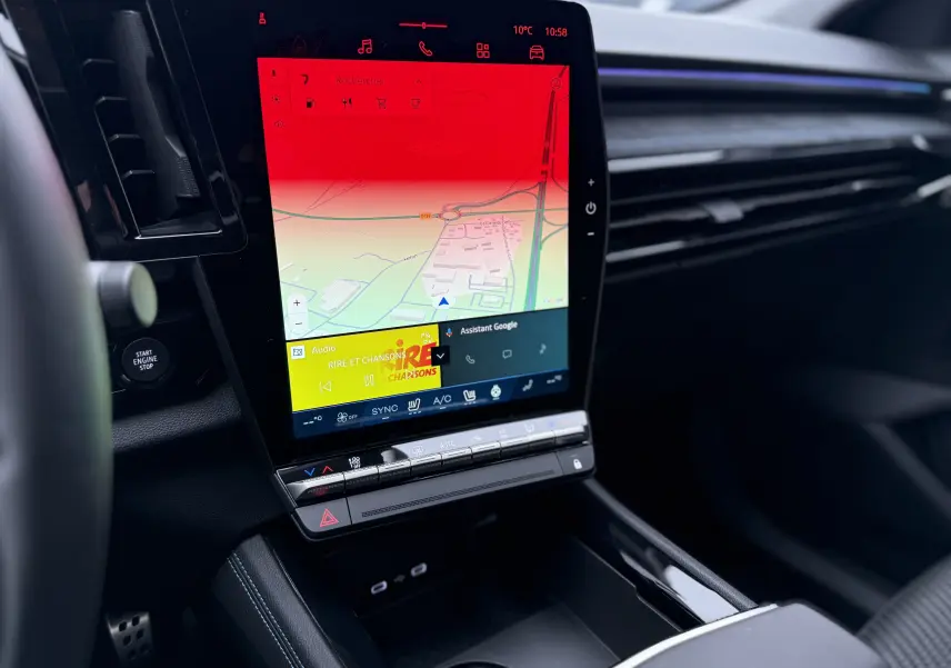Vue intérieure du tableau de bord du Renault Austral 2025, écran tactile vertical avec navigation et commandes climatisation.