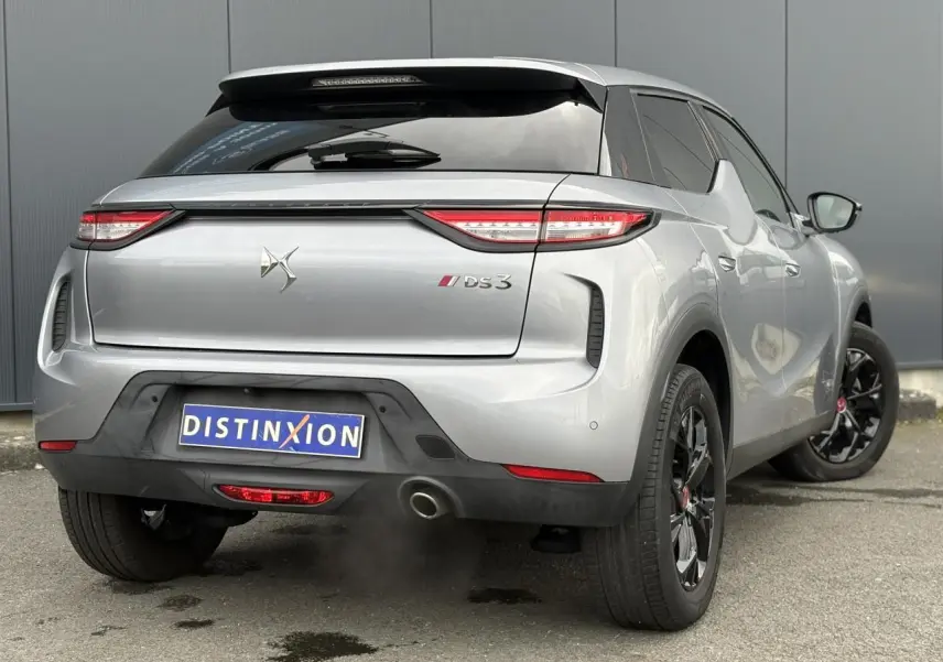 Vue 3/4 arrière droite d’un DS3 Crossback gris Artense avec jantes noires et feux arrière LED distinctifs.