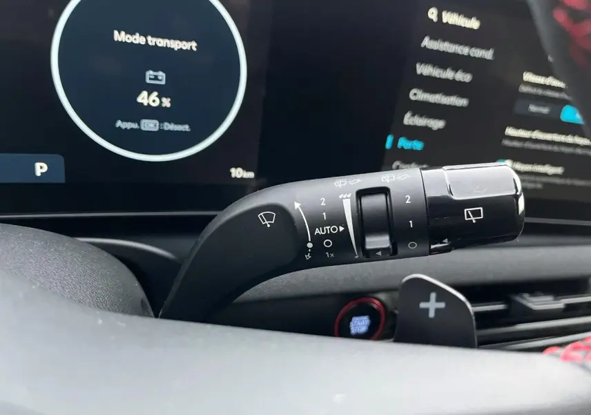 Gros plan sur la manette d’essuie-glace du Hyundai Tucson 2025, intérieur noir avec tableau de bord digital en arrière-plan.