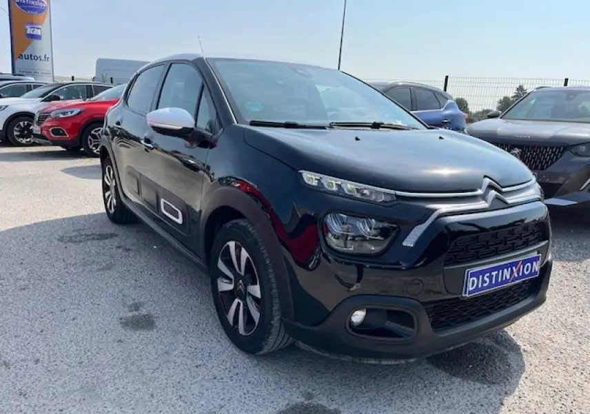 Citroën C3 noire vue en 3/4 avant droit, avec jantes alliage diamantées et rétroviseurs blancs contrastants.