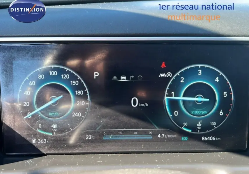 Tableau de bord numérique du Hyundai Tucson gris foncé, affichant vitesse, compte-tours et informations de conduite.