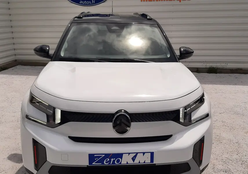 Vue avant d'une Citroën C3 Aircross 2026 blanc banquise avec toit noir, calandre noire et phares LED distinctifs.