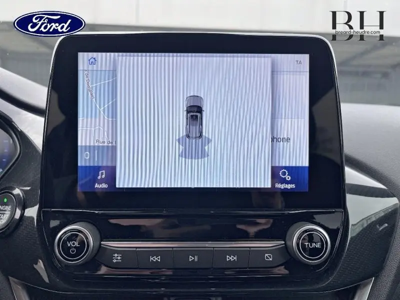 Écran tactile central du Ford Puma 2021 affichant la vue aérienne du véhicule avec commandes audio en dessous.