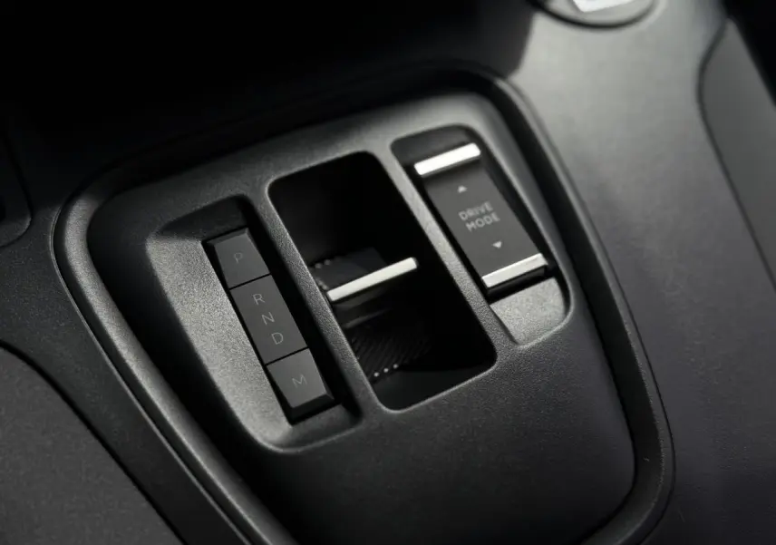 Gros plan sur la console centrale noire du Peugeot Rifter 2026, avec commandes de boîte auto et mode de conduite.