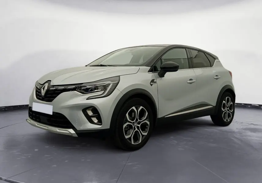 Renault Captur E-Tech hybride 2023 gris alu/noir en 3/4 avant droit, avec jantes alliage et toit noir contrasté.