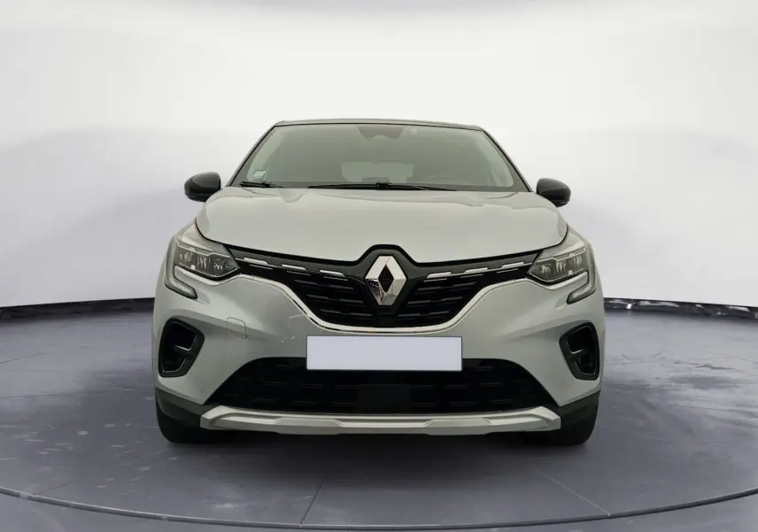 Vue avant du Renault Captur E-Tech Full Hybrid 145 Techno 2023 en gris alu avec toit noir et calandre noire distinctive.