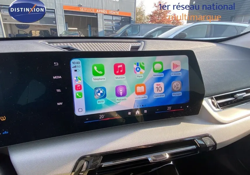 Écran tactile central du tableau de bord d'une BMW X1 18I 2024 avec interface Apple CarPlay affichée.