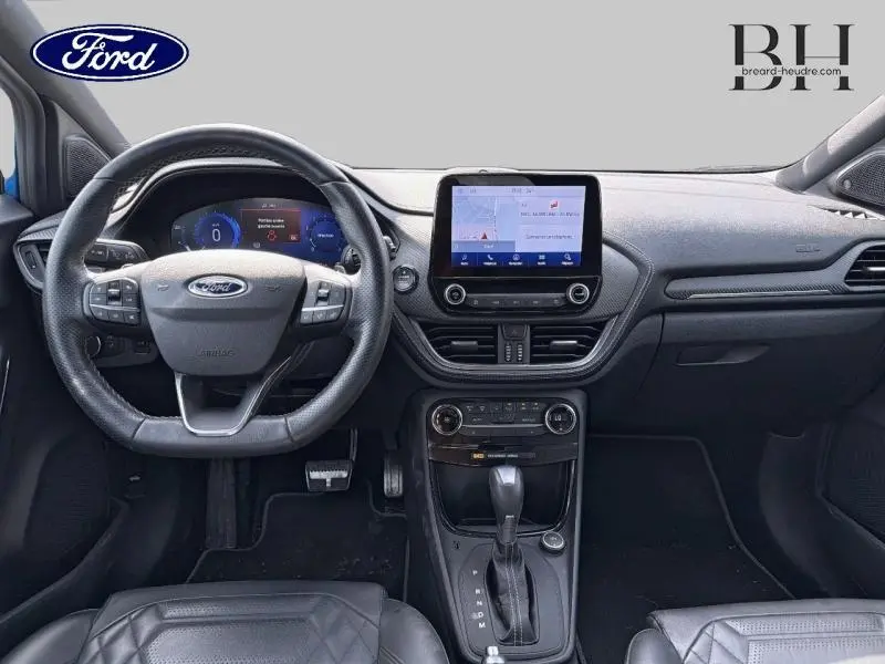 Vue intérieure avant du Ford Puma 2020 avec volant cuir multifonction et écran tactile central lumineux.
