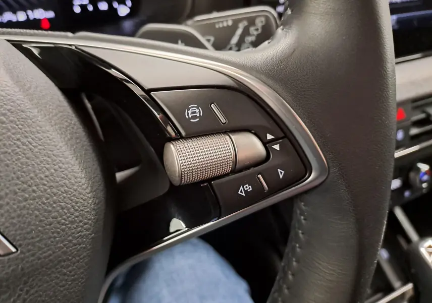 Gros plan sur les commandes multifonctions à droite du volant en cuir noir du Skoda Scala 2025.