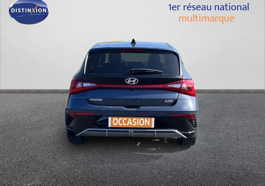 Vue arrière d'une Hyundai i20 gris aurora metal avec feux arrière en bandeau lumineux et plaque "OCCASION".
