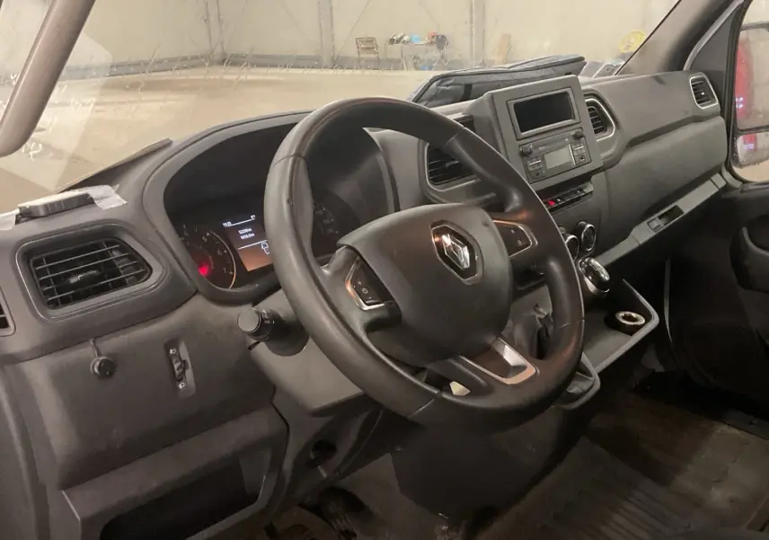 Vue intérieure côté conducteur du Renault Master Cabine Approfondie blanc, tableau de bord avec volant multifonction et écran central.