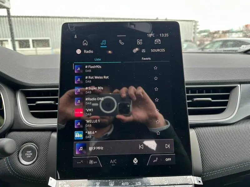 Écran tactile central du Renault Captur 2026 en gris Cassiopée/Noir Étoilé, affichant la radio DAB, vue intérieure frontale.