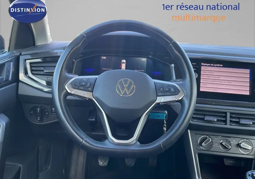 Vue intérieure centrée sur le volant noir du Volkswagen Taigo 2022 avec tableau de bord numérique et écran tactile.