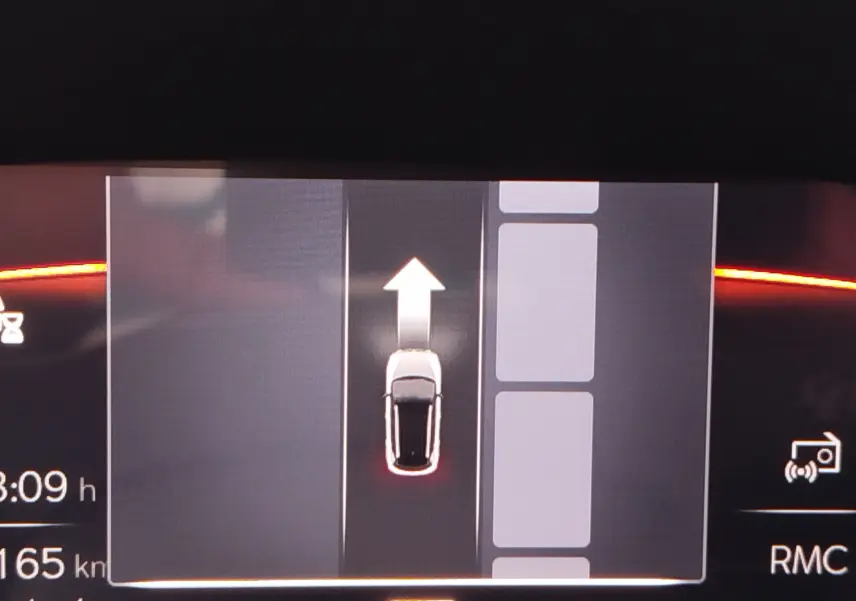 Affichage numérique du tableau de bord montrant la voiture blanche en vue de dessus avec une flèche indiquant la direction vers l'avant.