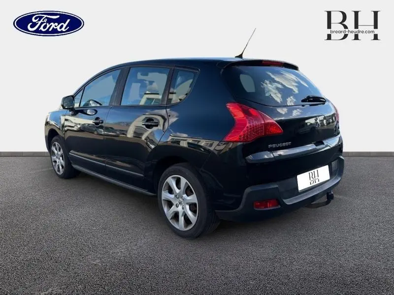 Vue 3/4 arrière droite d’un Peugeot 3008 noir Perla Nera avec jantes alu et feux arrière distinctifs.