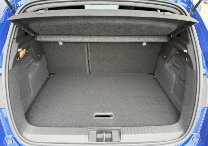 Coffre ouvert vu de l'arrière du Renault Captur bleu Iron, montrant un espace de chargement propre et spacieux.