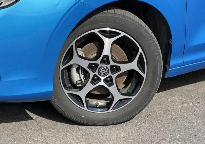 Gros plan sur la roue avant gauche de la MG3 1.5 Hybrid+ 195 Comfort bleu Como avec jante alliage 16 pouces.