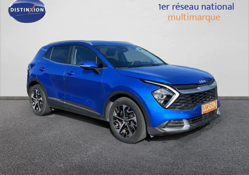 KIA Sportage bleu fusion métal en 3/4 avant droit, mettant en valeur sa calandre distinctive et ses jantes stylées.